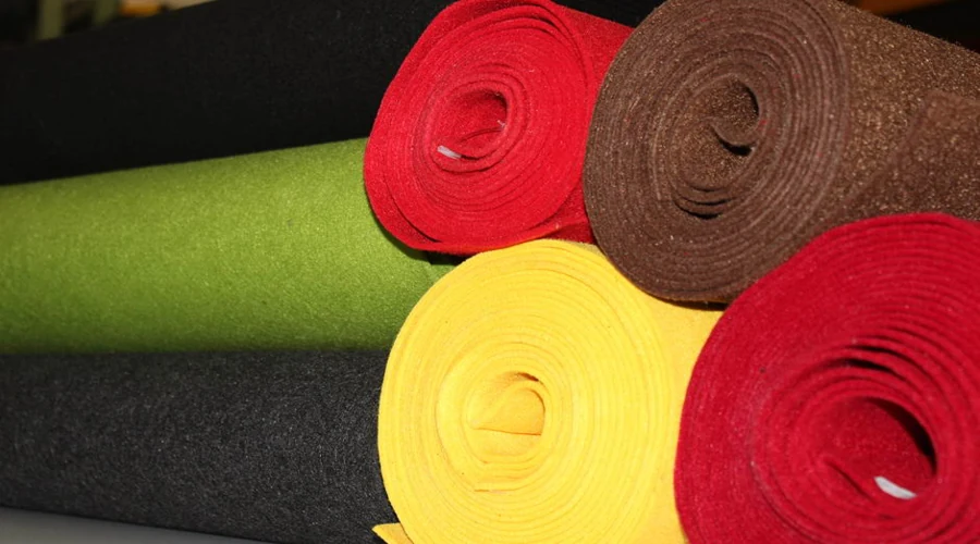 Stacked rolls of colorful exhibition carpet material