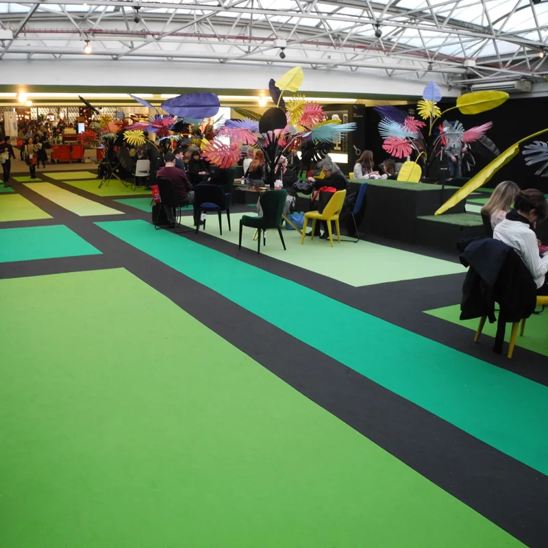 Green carpet walkway at indoor event