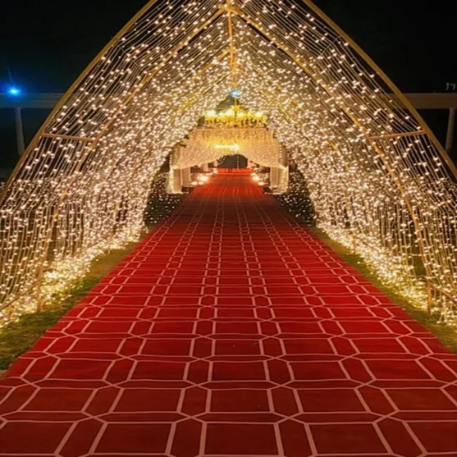 Patterned red exhibition carpet under fairy lights