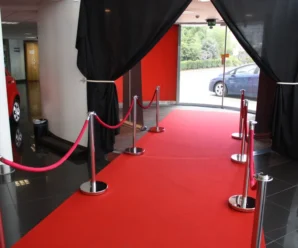 Red exhibition carpet entrance with stanchion ropes