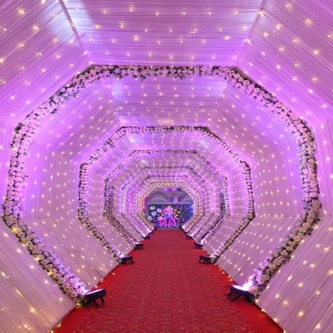 Red exhibition carpet runner in illuminated tunnel